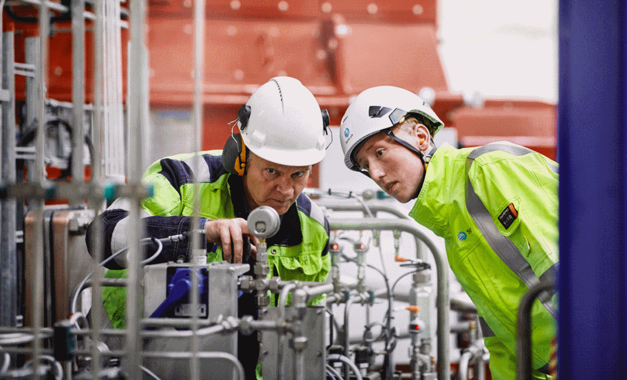 Two employees inspecting technical equipment